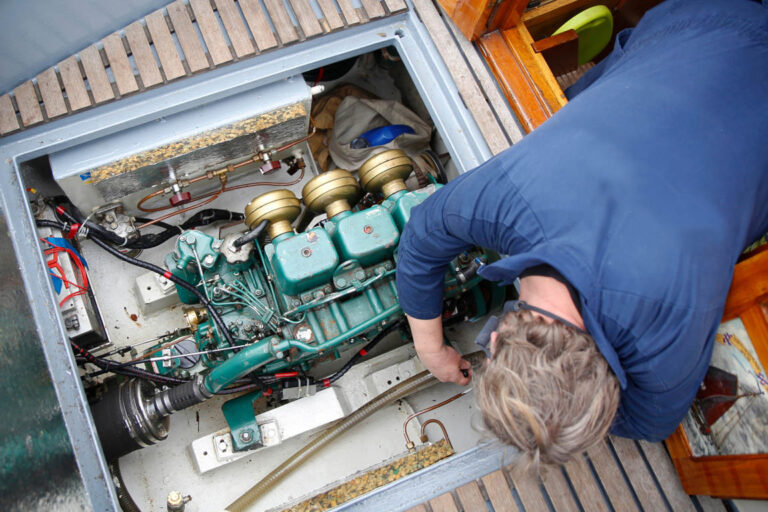 A service engineer fixing the engine of a vessel
